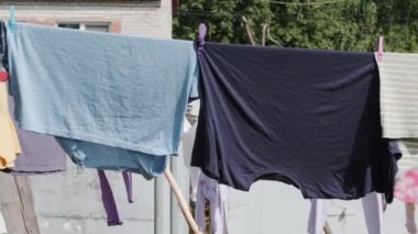 Various clothes are drying on the laundry line against the backdrop of the village.