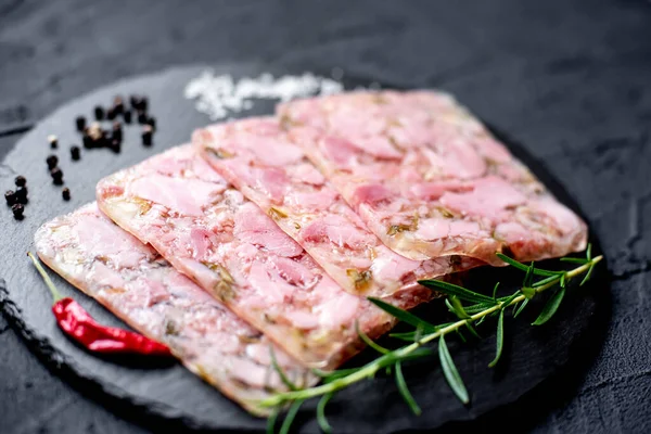 stock image Head cheese or brawn, jelly meat with spices and herbs, close up view