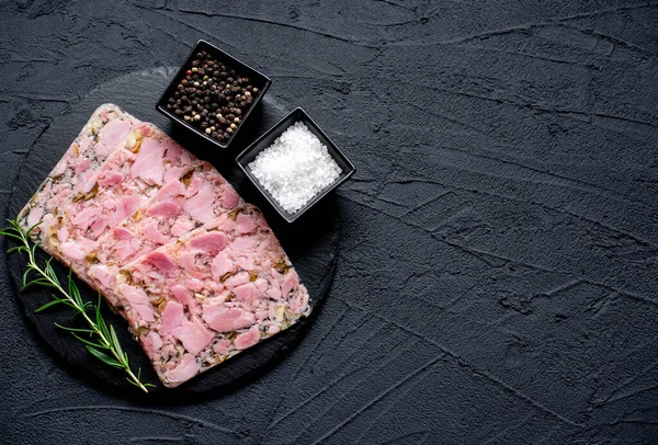 stock image Head cheese or brawn, jelly meat with spices and herbs, close up view