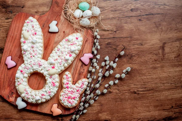 stock image easter rabbit shaped cookies with eggs, conceptual image