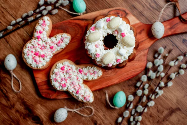 stock image Easter cookies with decorative eggs on wooden board