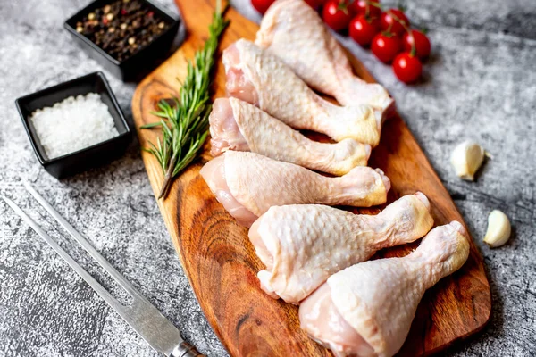 stock image raw chicken legs on wooden board, top view