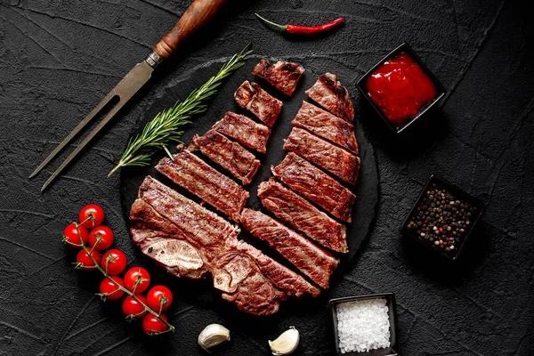 Krájený Grilovaný Hovězí Steak Kořením Rozmarýnem Černém Pozadí Pohled Shora — Stock fotografie