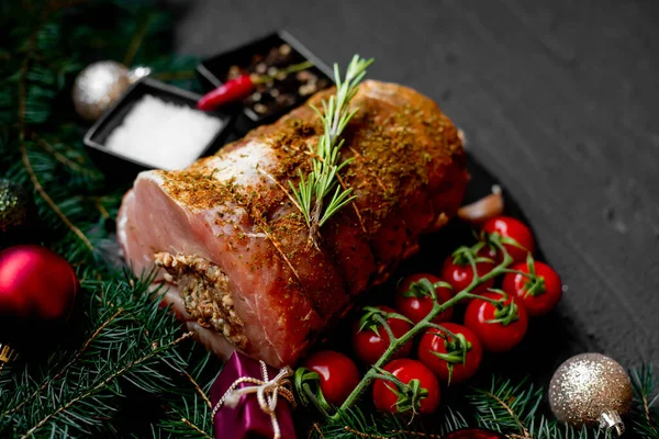Christmas food concept. Raw meat with spices and Christmas decorations on rustic background