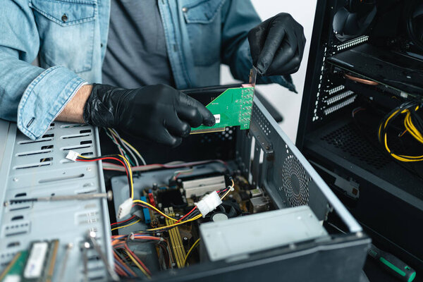 Close up of man hands wearing gloves repairing desktop computer. Pc repairing service concept