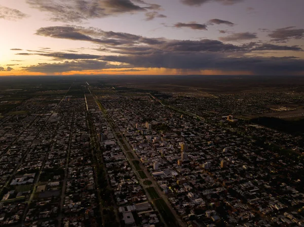 Aerial city landscape at cloudy sunset. Drone panoramic view. General Roca, Rio Negro, Argentina