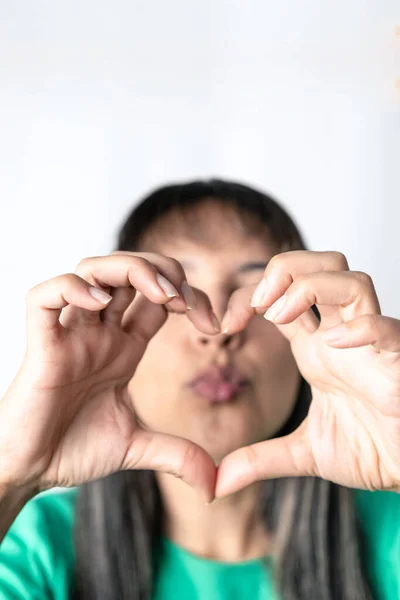 Young Woman Making Heart Shape Her Fingers White Background Vertical Stockbild