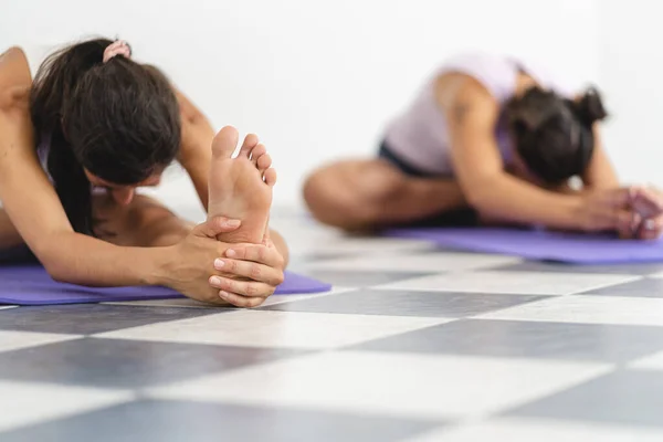 Close Shot Two Women Doing Yoga While Stretching Janu Sirsasana Royalty Free Φωτογραφίες Αρχείου