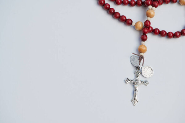 A beautifully crafted rosary lies on a white surface, inviting prayer and reflection.