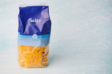 Mainz, Germany - January 18, 2025: clear package of gluten-free noodles by Seitz against a soft pastel backdrop. clipart