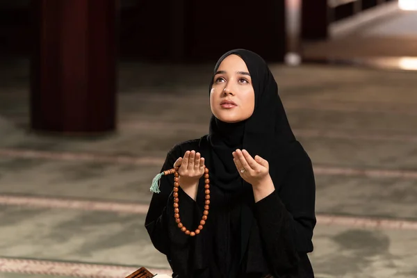 Humble Muslim Woman Holding Hands Up and Praying in Peace