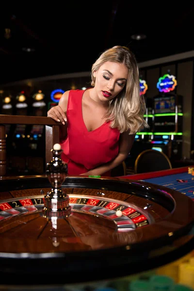 Portrait Young Caucasian Blonde Woman Wearing Red Dress Leaning Roulette — Stock Photo, Image