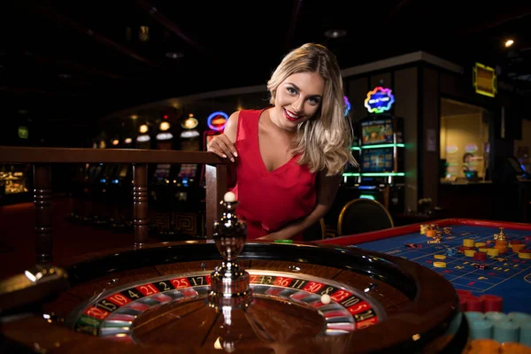 Portrait Young Caucasian Blonde Woman Wearing Red Dress Leaning Roulette — Stock Photo, Image