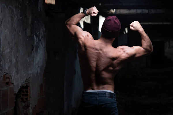 Healthy Young Man Winter Hat Standing Strong Flexing Back Muscles — Stock Photo, Image