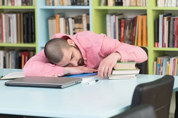 Sleeping Man Student Sitting And Leaning On Pile Of Books In College
