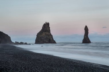 Bazalt kaya oluşumları Troll siyah kumsalda ayak parmakları. Reynisdrangar, Vik, İzlanda
