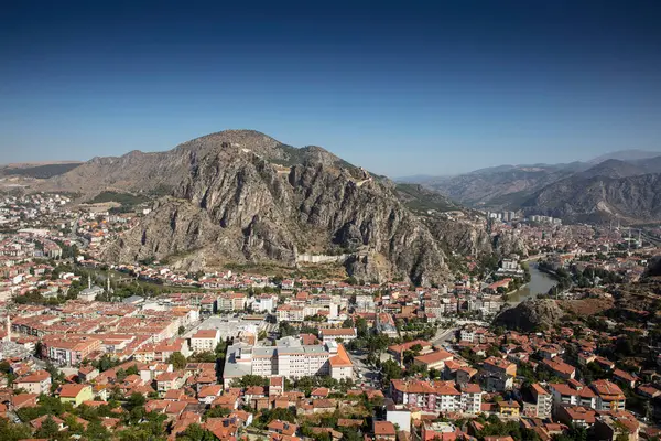 stock image Amasya,TURKEY old riverside Turkish(ottoman) city buildings and its reflection on water,sunny summer day.Amasya is city of princes of ottoman. ottoman Princes were educated in Amasya