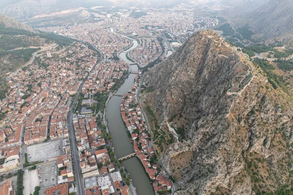 stock image Amasya,TURKEY old riverside Turkish(ottoman) city buildings and its reflection on water,sunny summer day.Amasya is city of princes of ottoman. ottoman Princes were educated in Amasya