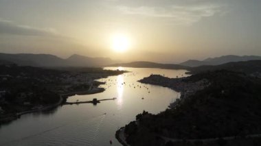 Yunanistan 'ın Saronik Körfezi' ndeki Poros Adası 'nın havacılık manzarası, renkli bir yaz günbatımında