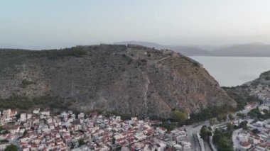 Yunanistan 'da Nafplion şehrinin bulunduğu yeşil yarımada mavi Akdeniz, eski kasaba çatıları ve küçük liman