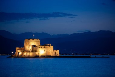 Bourtzi water fortress in Nafplio at night. Nafplio is a seaport town in the Peloponnese peninsula in Greece. clipart