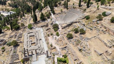 Delphi, Phocis / Yunanistan. Delphi Antik Tiyatrosu. 5.000 seyirci kapasiteli tiyatro Apollo 'nun sığınağında yer almaktadır. Güneşli bir günde bulutlu bir gökyüzü ile panoramik manzara