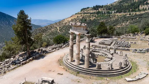 Delphi, Phocis / Yunanistan. Delphi Antik Tiyatrosu. 5.000 seyirci kapasiteli tiyatro Apollo 'nun sığınağında yer almaktadır. Güneşli bir günde bulutlu bir gökyüzü ile panoramik manzara