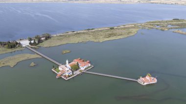 Yunanistan 'ın Porto Lagos kentindeki Vistonida Gölü üzerindeki Agios Nikolaos Manastırı üzerindeki hava aracı görüntüsü