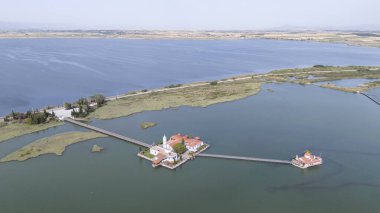 Aerial drone view od Agios Nikolaos Monastery on the Vistonida Lake at Porto Lagos, Greece clipart