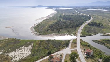 Aerial drone view od Agios Nikolaos Monastery on the Vistonida Lake at Porto Lagos, Greece clipart