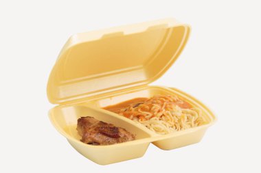 Chicken and pasta in a plastic box for delivery. Isolated over white background. Close-up.