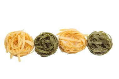 Italian fettuccine pasta in the form of a nest. Isolated over white background. Close-up.