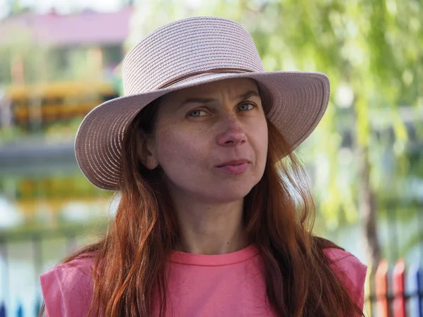 stock image Portrait of a girl of European appearance in a hat from the sun with long hair dyed with henna