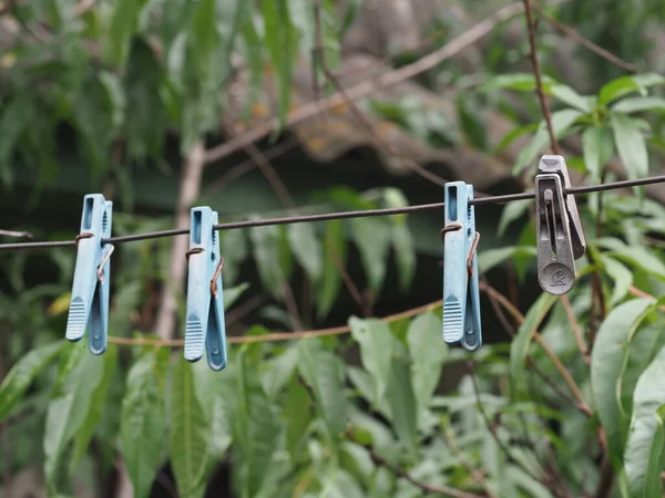 old clothespins on a wire in a country yard for drying clothes