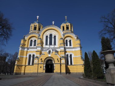The facade of Volodymyr's Cathedral in Kyiv against the background of a cloudless blue sky