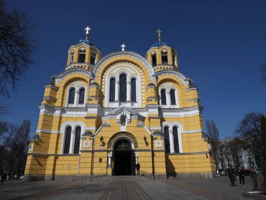 The facade of Volodymyr's Cathedral in Kyiv against the background of a cloudless blue sky
