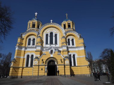 The facade of Volodymyr's Cathedral in Kyiv against the background of a cloudless blue sky