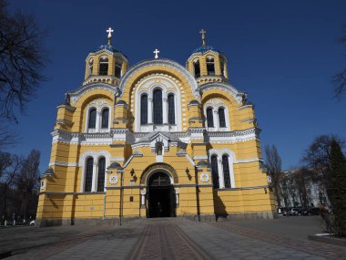 The facade of Volodymyr's Cathedral in Kyiv against the background of a cloudless blue sky
