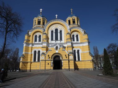 The facade of Volodymyr's Cathedral in Kyiv against the background of a cloudless blue sky