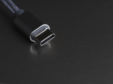 Koyu arkaplan üzerinde USB Tip-C kablosu, yakın plan, seçici odak