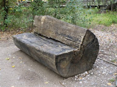 Rustic Wooden Log Bench in Forest Park Setting with Natural Surroundings clipart