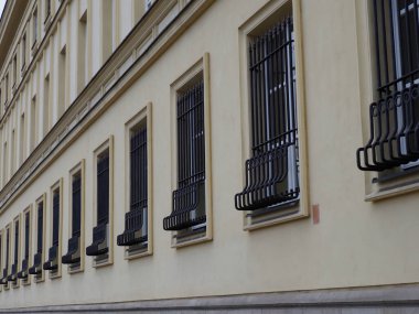 Avrupa 'da Dekoratif Metal Pencere Korumaları ve Krem Renkli Cephesi ile Tarihi Bina