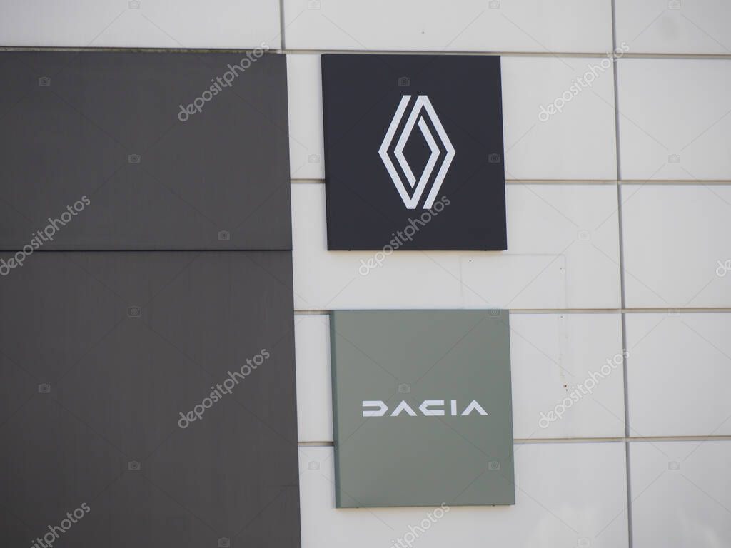 Modern Automotive Dealership Wall Display with Renault and Dacia Corporate Logos on White Tile Background