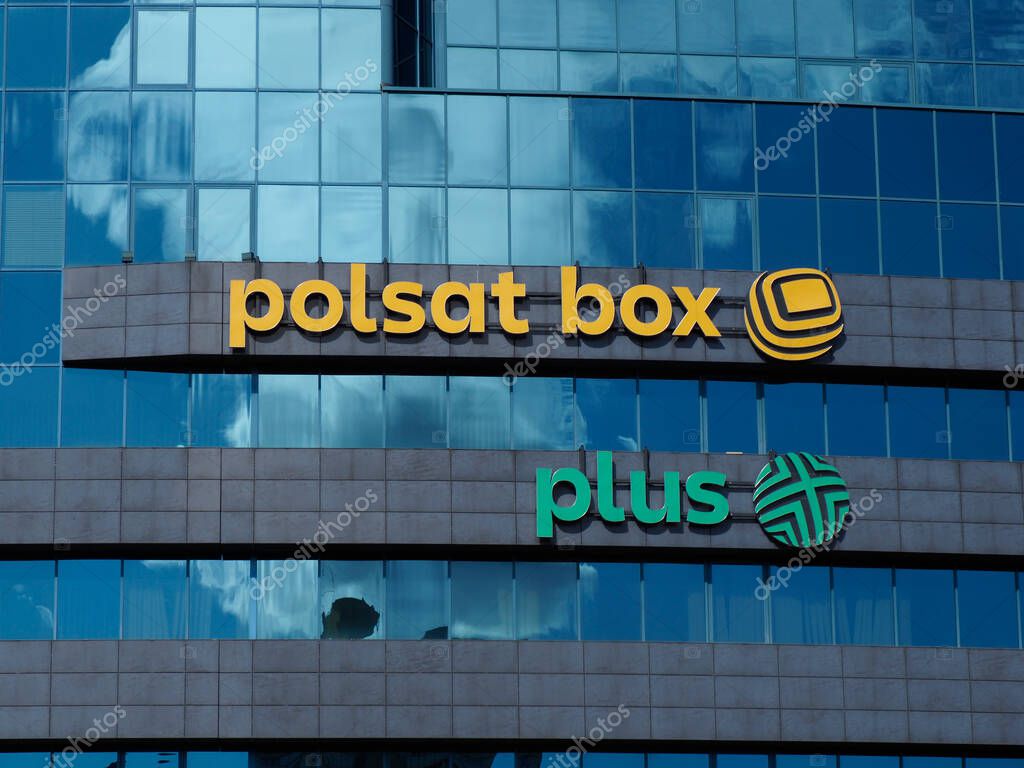 Polsat Box and Plus Logos on Modern Blue Glass Office Building Facade in Corporate Business District