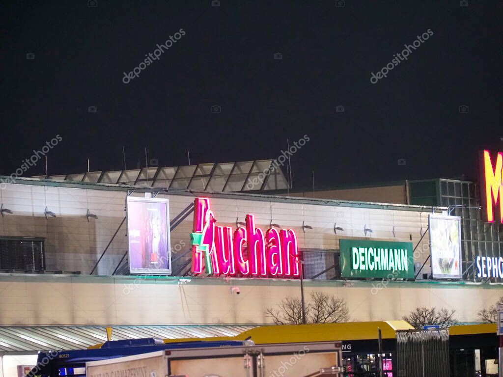 Illuminated Commercial Shopping Center at Night Featuring Multiple Store Logos