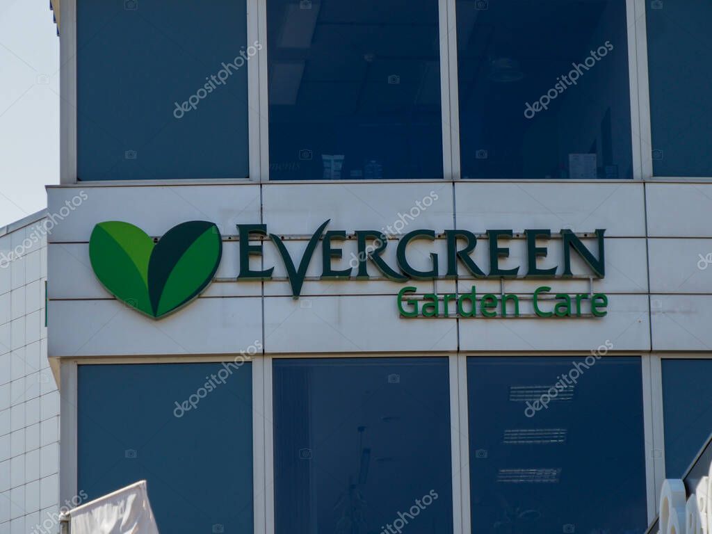 Evergreen Garden Care Company Logo on Corporate Office Building with Green Leaf Symbol