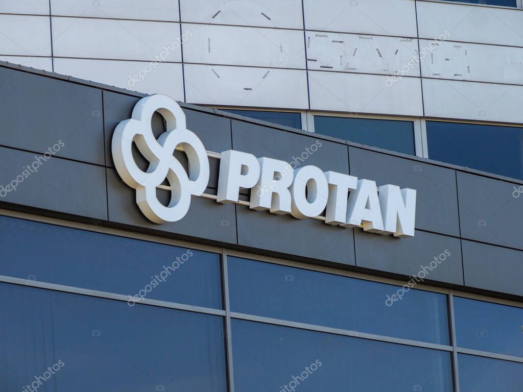Protan Company Logo with Infinity Symbol on Modern Corporate Building with Glass Facade