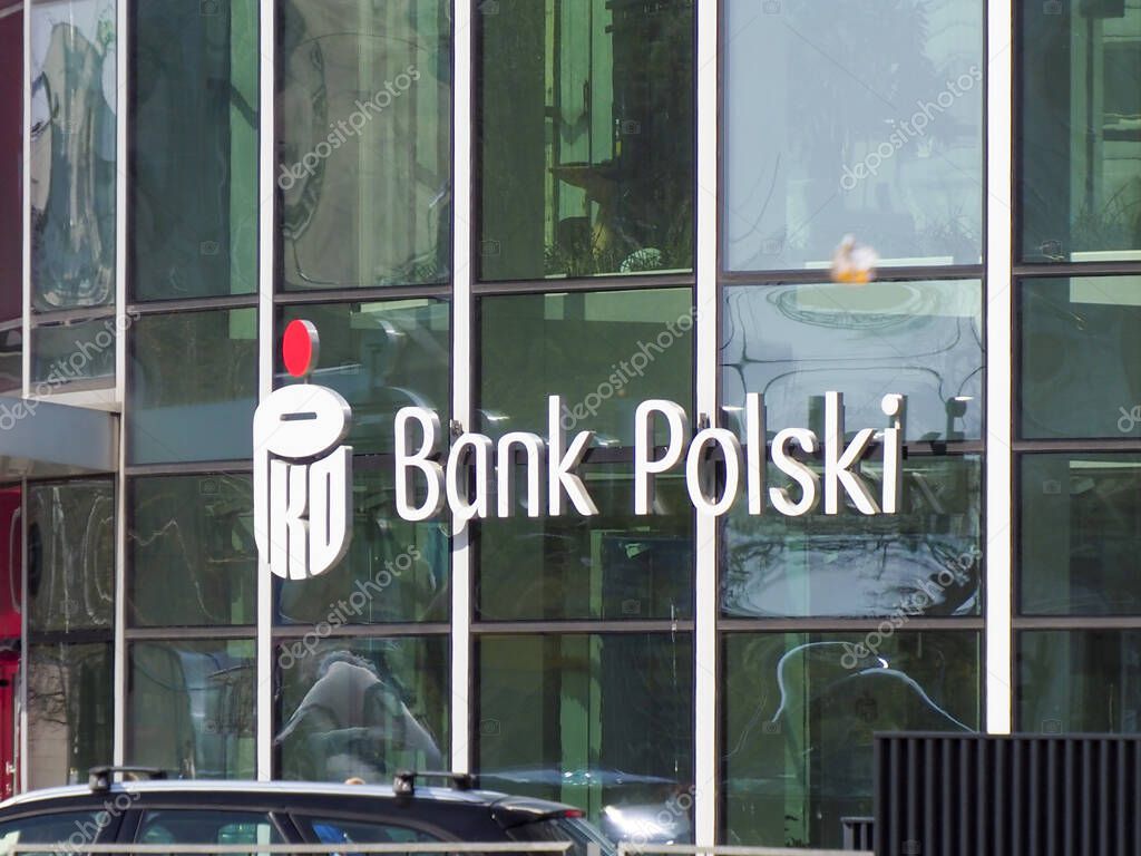 Modern Bank Polski Branch Office with Glass Facade Reflecting Urban Environment in Warsaw Financial District