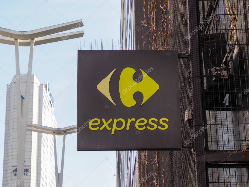 Carrefour Express Black and Yellow Sign on Urban Building Wall with Distinctive Square Logo