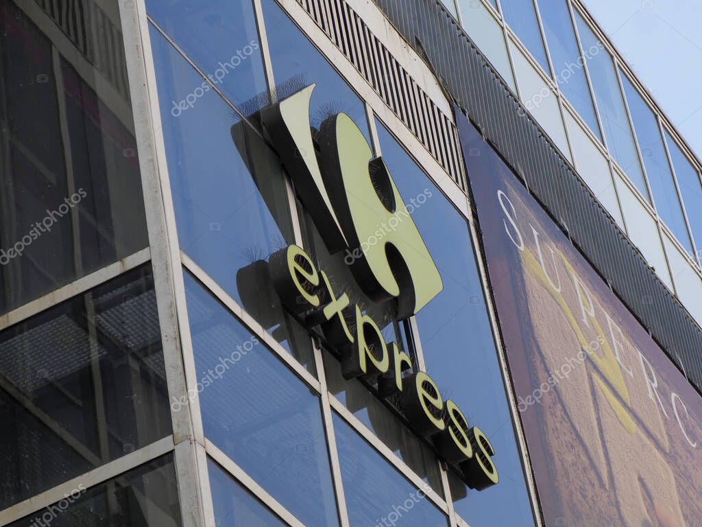 Carrefour Express Sign on Glass Building Corner with Angled Perspective in Urban Setting
